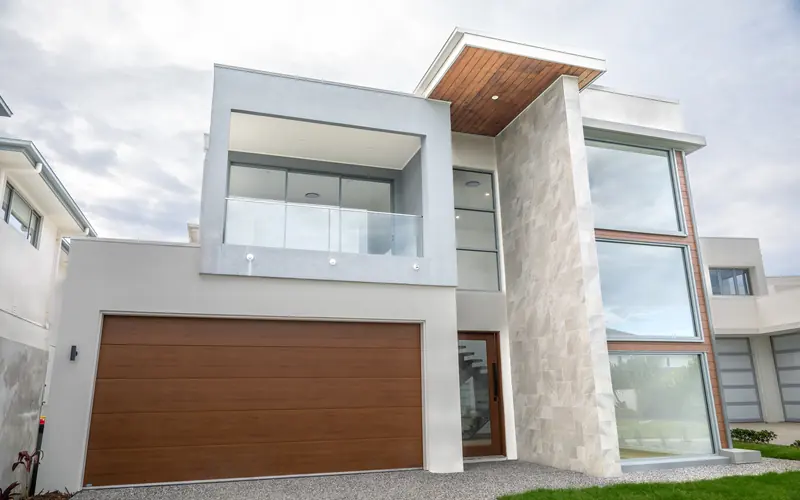 Completed two-storey home with rendered and timber-clad facade